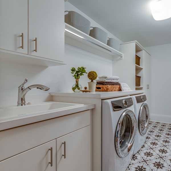 laundry room with sink and various cabinets